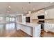 Modern kitchen features a large white center island, stainless steel appliances, and wood floors at 3360 Pickens St, Duluth, GA 30096