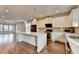 Modern kitchen features a large white center island, stainless steel appliances, and wood floors at 3360 Pickens St, Duluth, GA 30096