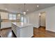 Kitchen featuring a large island, white cabinets, stainless appliances and wood floors at 3360 Pickens St, Duluth, GA 30096