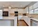 Kitchen featuring stainless steel appliances, white cabinets, tile backsplash and hardwood floors at 3360 Pickens St, Duluth, GA 30096