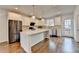 Kitchen featuring a large island, stainless appliances, white cabinets and wood floors at 3360 Pickens St, Duluth, GA 30096