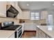 Modern kitchen features stainless steel appliances, beautiful countertops, and lots of cabinet space at 3360 Pickens St, Duluth, GA 30096