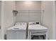 Well-organized laundry room equipped with modern washer and dryer, complemented by a convenient wire shelf above at 3360 Pickens St, Duluth, GA 30096