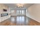 Hardwood flooring and modern fireplace enhance this open living room, filled with natural light from many windows at 3360 Pickens St, Duluth, GA 30096