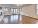 Bright and airy living room featuring hardwood floors, large windows, and a modern chandelier at 3360 Pickens St, Duluth, GA 30096