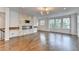 Sunlit living room with hardwood floors, a contemporary fireplace, and multiple windows offering views at 3360 Pickens St, Duluth, GA 30096