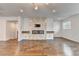 Spacious living room with hardwood floors, fireplace, recessed lighting, and a modern chandelier at 3360 Pickens St, Duluth, GA 30096