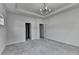 Spacious main bedroom featuring neutral walls, plush carpet and a modern light fixture at 3360 Pickens St, Duluth, GA 30096