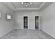 Spacious main bedroom with tray ceiling, modern light fixture, and walk-in closet at 3360 Pickens St, Duluth, GA 30096