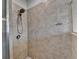 Shower features tiled walls, rainfall showerhead, and grab bar for added safety at 3360 Pickens St, Duluth, GA 30096