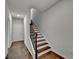 An interior view of a staircase with white risers, dark treads, wooden handrail and hardwood floors at 3360 Pickens St, Duluth, GA 30096