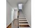 An interior view of a staircase with white risers, dark treads and hardwood floors at 3360 Pickens St, Duluth, GA 30096