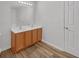 Bathroom featuring double sink vanity, wood floors, and bright lighting at 7459 Old Chapel, South Fulton, GA 30349