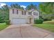 Traditional two-story home with a clean exterior, attached garage, and landscaped front yard at 7459 Old Chapel, South Fulton, GA 30349