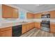 An updated kitchen features stainless steel appliances, wood cabinets, and a view to the backyard at 7459 Old Chapel, South Fulton, GA 30349
