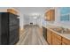 Open-concept kitchen with stainless steel appliances and hardwood floors at 7459 Old Chapel, South Fulton, GA 30349