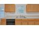 Kitchen featuring wood cabinets, stainless steel sink, and a dishwasher at 7459 Old Chapel, South Fulton, GA 30349