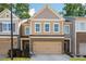Charming two-story townhome featuring a brick facade and a convenient attached garage for easy parking and storage at 813 Whittington Parkway Sw, Marietta, GA 30060