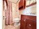 Cozy bathroom featuring a cherry vanity, toilet, and shower stall at 1183 Iron Gate Blvd, Jonesboro, GA 30238