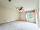 Bright bedroom with a ceiling fan, window, and neutral wall color at 1183 Iron Gate Blvd, Jonesboro, GA 30238