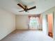 Spacious bedroom featuring a ceiling fan and a view of the outdoors at 1183 Iron Gate Blvd, Jonesboro, GA 30238