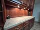 Close-up of built-in buffet area with a beadboard backsplash, lighting, and storage at 1183 Iron Gate Blvd, Jonesboro, GA 30238