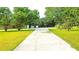 Long driveway leading to the house, flanked by green lawns and mature trees at 1183 Iron Gate Blvd, Jonesboro, GA 30238