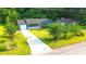 Single story home featuring mature trees, spacious driveway and inviting front porch at 1183 Iron Gate Blvd, Jonesboro, GA 30238