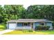 Charming single-story home with a well-manicured lawn, blue siding, and a cozy front porch at 1183 Iron Gate Blvd, Jonesboro, GA 30238