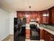 The kitchen features modern appliances, tile floors, and plenty of cabinet space at 1183 Iron Gate Blvd, Jonesboro, GA 30238