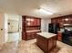 Well-lit kitchen featuring an island, wood cabinets, and black appliances at 1183 Iron Gate Blvd, Jonesboro, GA 30238