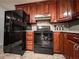 Well-equipped kitchen featuring sleek black appliances and ample wood cabinetry at 1183 Iron Gate Blvd, Jonesboro, GA 30238