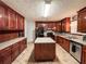 This kitchen features an island, stainless steel appliances, plenty of cabinet space, and a tiled floor at 1183 Iron Gate Blvd, Jonesboro, GA 30238