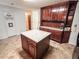 The kitchen features an island, tile floors, and plenty of cabinet space at 1183 Iron Gate Blvd, Jonesboro, GA 30238