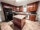 Updated kitchen with dark cabinets, stainless appliances, and center island at 1183 Iron Gate Blvd, Jonesboro, GA 30238