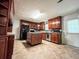 Modern kitchen featuring dark wood cabinets, black appliances, and a center island at 1183 Iron Gate Blvd, Jonesboro, GA 30238