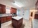 Bright kitchen with wood cabinets, island, and tile floors at 1183 Iron Gate Blvd, Jonesboro, GA 30238