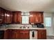 Traditional kitchen features wood cabinets, double basin sink, and a light-filled window at 1183 Iron Gate Blvd, Jonesboro, GA 30238