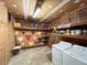 A laundry area with a washer and dryer along with shelving for storage and heart decorations on the wall at 1183 Iron Gate Blvd, Jonesboro, GA 30238