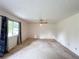 Bright living room with large windows, ceiling fan, and neutral carpet at 1183 Iron Gate Blvd, Jonesboro, GA 30238