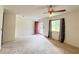 Cozy living room with natural light, ceiling fan, and red front door at 1183 Iron Gate Blvd, Jonesboro, GA 30238