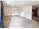 Spacious living room featuring neutral walls, ceiling fan, and view into the kitchen at 1183 Iron Gate Blvd, Jonesboro, GA 30238