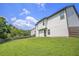 Backyard featuring a white house with a fenced in yard and green grass at 12225 Anchor Way, Hampton, GA 30228