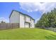 Large, grassy backyard with a wooden fence, perfect for outdoor activities and privacy at 12225 Anchor Way, Hampton, GA 30228