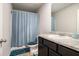 Bathroom with a granite countertop, and a blue shower curtain at 12225 Anchor Way, Hampton, GA 30228