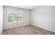 Bright bedroom featuring a window with blinds and neutral colored carpet at 12225 Anchor Way, Hampton, GA 30228