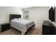 Well-lit bedroom with a padded headboard, a window, and a mounted television at 12225 Anchor Way, Hampton, GA 30228