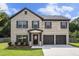 Charming two-story brick home with a two-car garage and well-maintained landscaping at 12225 Anchor Way, Hampton, GA 30228