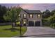 Charming brick two-story home with a well-manicured lawn and an attached two-car garage at 12225 Anchor Way, Hampton, GA 30228