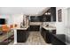 Modern kitchen features dark cabinets, granite countertops and stainless steel appliances at 12225 Anchor Way, Hampton, GA 30228